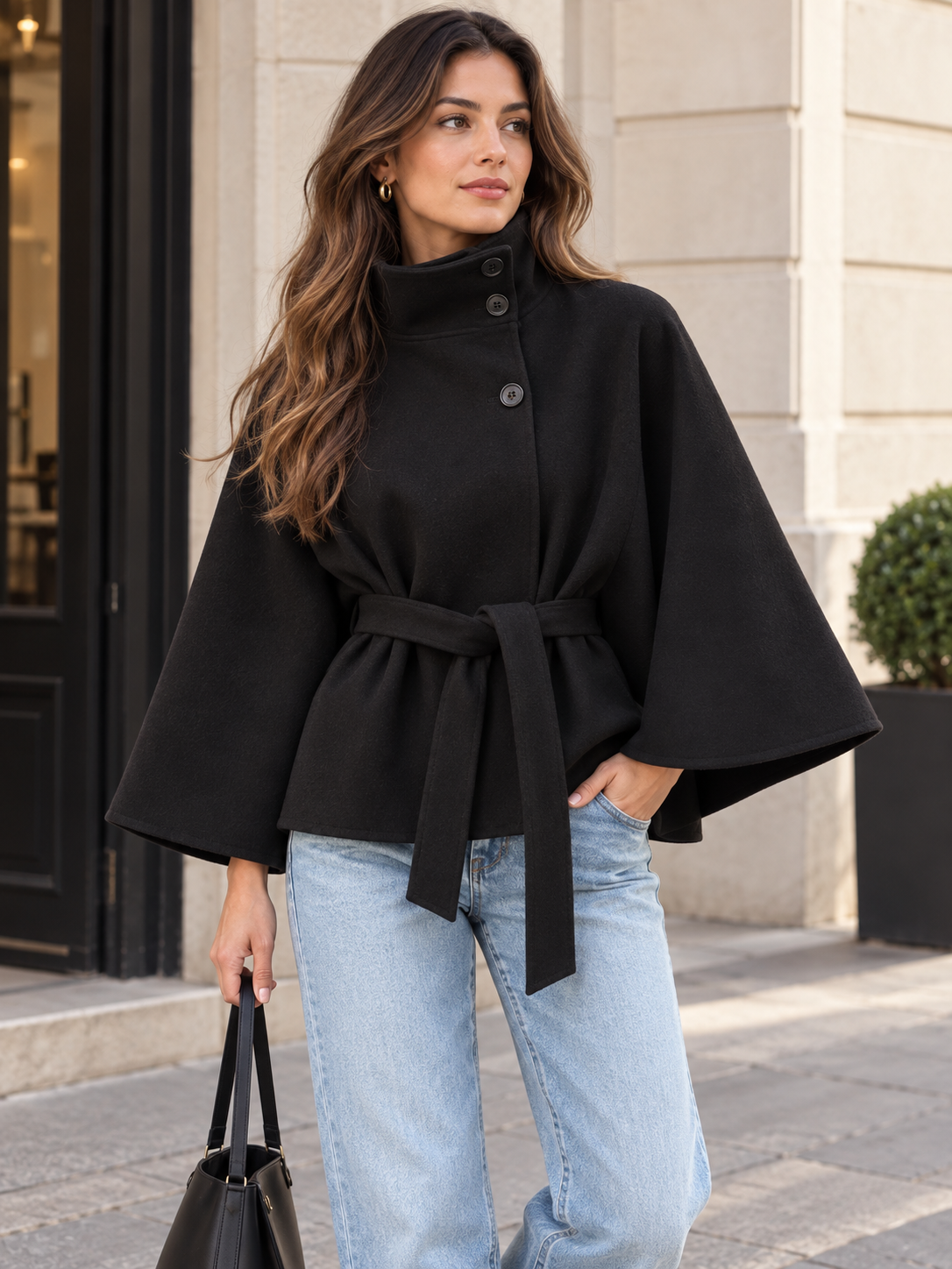 Rovelle high collar belted cape jacket in black on model